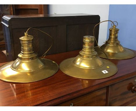 Three brass light shades