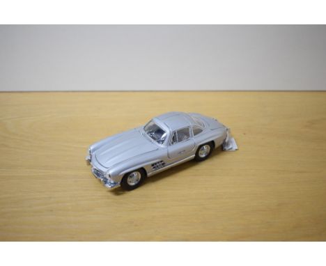 A 1987 Franklin Mint 1:24 scale Die-cast, 1954 Mercedes-Benz 300SL with tag and two Letters regarding care for your Mercedes 