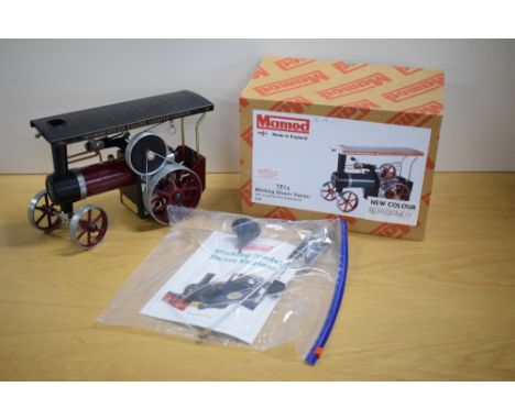 A Mamod Limited Edition Steam 4 Fun Live Steam TE1A Steam Tractor, silver boiler, maroon body and hubs with black canopy, inc