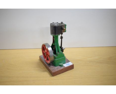 A Stuart Turner live steam model of a vertical cylinder engine, the cast iron frame finished in green, height 15cm, diameter 