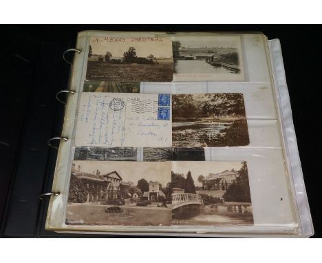 A large collection of vintage postcards contained within an album to include real photograph and printed examples including l