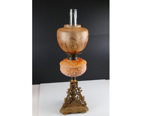 Late 19th / Early 20th century Oil Lamp with peach coloured embossed ceramic font, decorative metal base with peach etched an