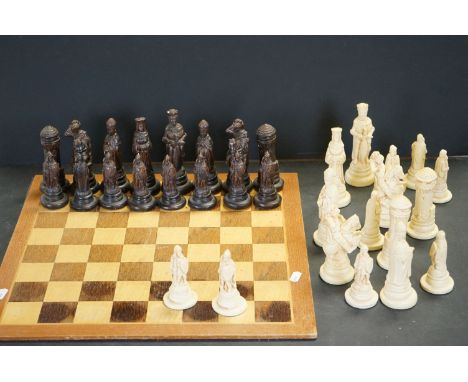 A resin figural chess set together with one piece wooden board. 