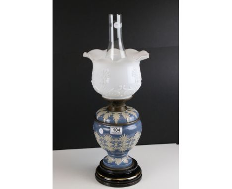 Late 19th / Early 20th century Doulton Stoneware Oil Lamp decorated with applied cream flowers and leaves on a blue ground, o