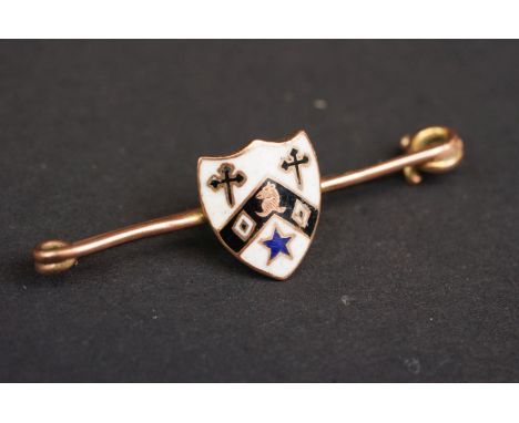 A fully hallmarked 9ct gold bar brooch with decorative enamel shield. 