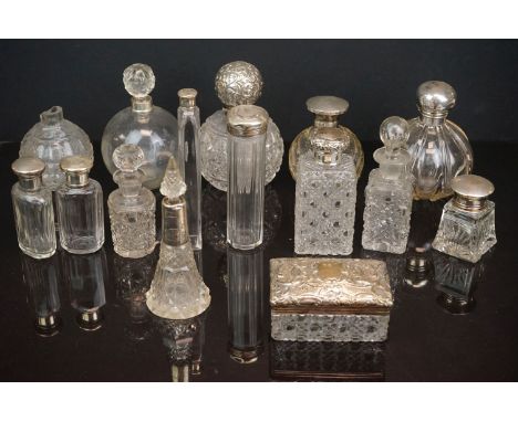 A collection of vintage scent and dressing table bottles to include many silver topped and collard examples. 