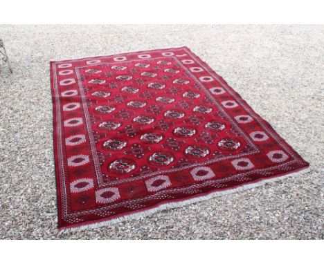 Rich red ground full pile Turkmen double knot carpet, with allover Bokhara design, approx. 290cm x 220cm 