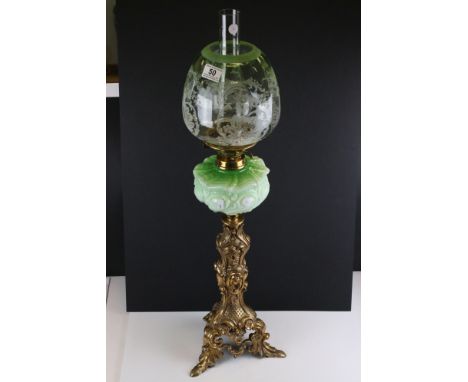 Late 19th / Early 20th century Oil Lamp with green embossed glass font, tall ornate brass base and green floral etched beehiv