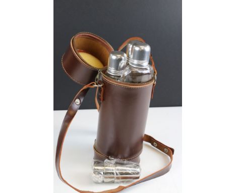 Leather cased triple spirit flask, set with three cups in separate compartments 