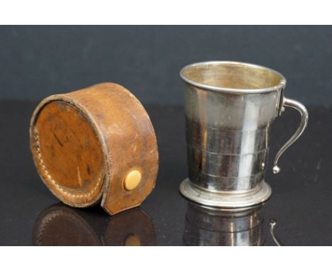 A vintage folding stirrup cup with folding handle complete with brown leather case. 