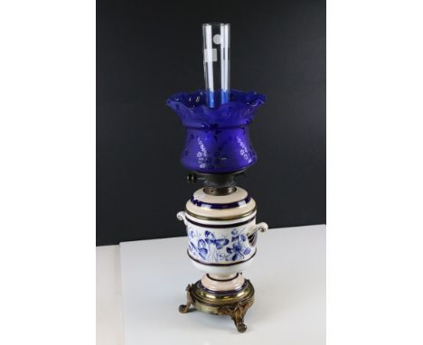 Late 19th / Early 20th century Hinks Oil Lamp, the cream ceramic drop in font decorated with blue birds, butterflies and flow