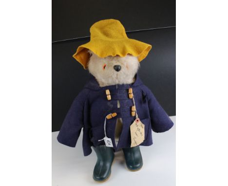 A vintage Gabrielle Paddington bear with blue duffle coat and green dunlop boots.