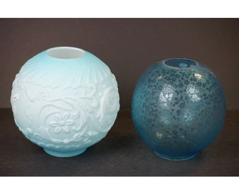 A turquoise floral etched round oil lamp shade together with a large round opaque turquoise oil lamp shade with floral decora