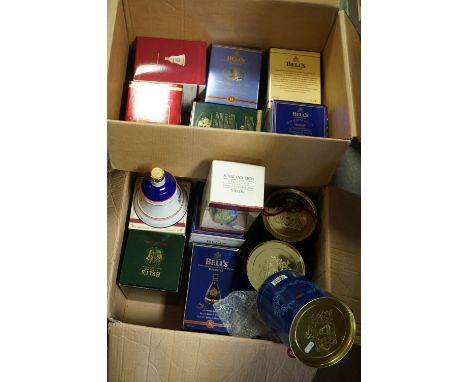 A large collection of mainly Wade commemorative ceramic whisky bottles, mostly with contents. 