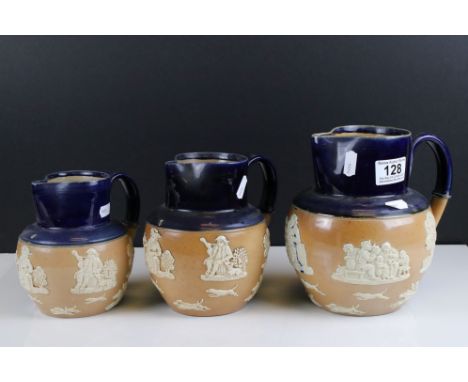 Set of Three graduating Royal Doulton Stoneware Jugs with partial blue glaze and applied hunting scene decoration, largest 19