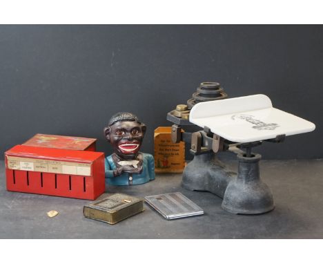 A group of mixed collectables to include cast iron scales complete with weights, vintage money boxes, cigarette dispenser..et