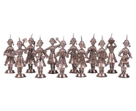 A set of twelve Nepalese silver alloy figures of musicians or dancers, early 20th century, each musician is holding a differe