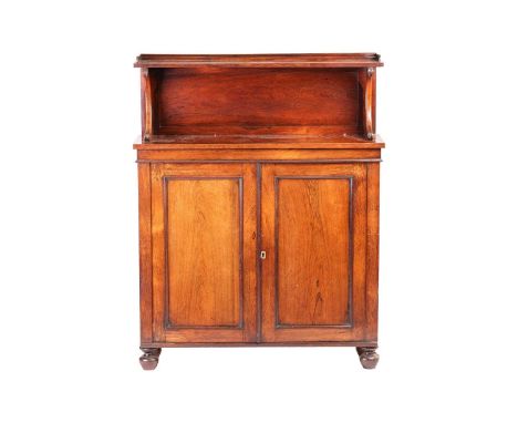 A Regency rosewood chiffonier with scroll supported upstand back over a pair of square panel doors, on turned bun feet. 102 c