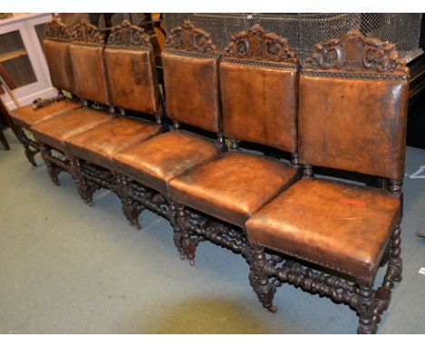 A set of six leather upholstered dining chairs in Carolean style, two similar oak and inlaid ladder back chairs in early 18th