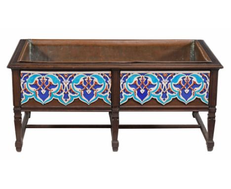 An Arts and Crafts hardwood and tiled planter,  circa 1900, the hardwood frame enclosing copper liner and housing six polychr