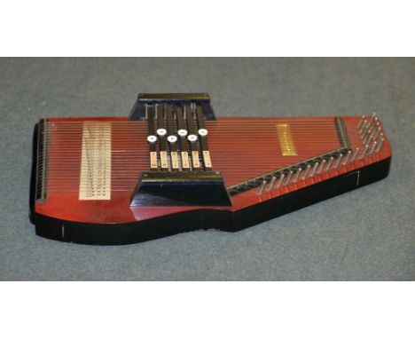 A stained wood Autoharp (zither), and an associated zither playing manual 