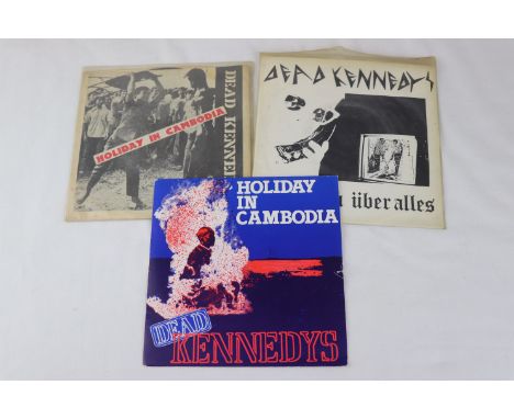 PUNK SINGLES - THE DEAD KENNEDYS - 2 ORIGINAL US 1ST PRESSING SINGLES + 1 UK 1ST PRESSING SINGLE.  1. HOLIDAY IN CAMBODIA ( 1