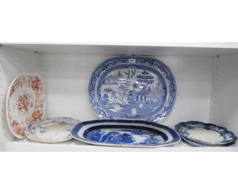 Six Victorian and later pottery ashets to include 'Willow' pattern (one shelf). 