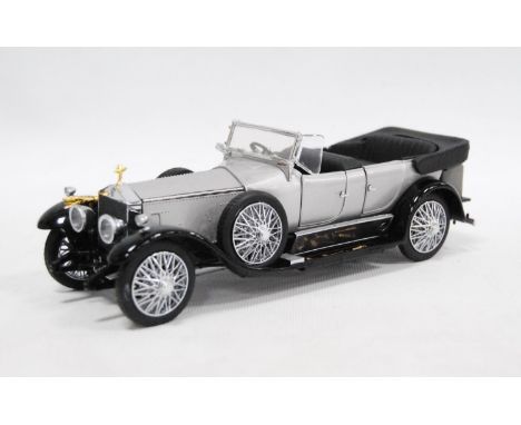 Franklin Mint model of a Rolls Royce Silver Ghost, 1925, enclosed in a glazed display case.