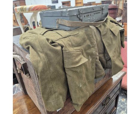 A vintage military uniform, a pine trunk, and an ammo box. 