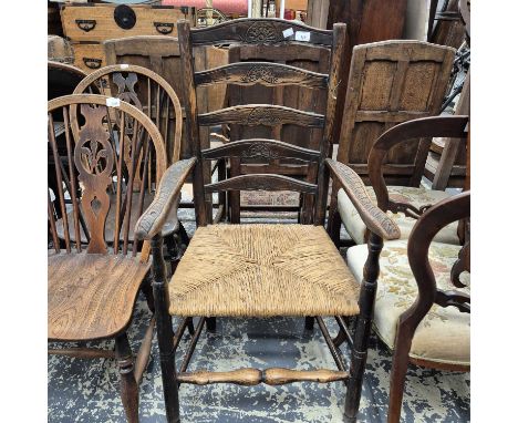 A 19th-century rush seat ladder back armchair. 
