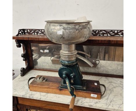 A vintage hand cranked coffee grinder.