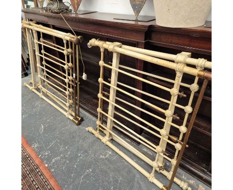 A pair of iron and brass single bed ends.