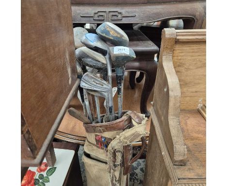 A bag of vintage golf clubs.
