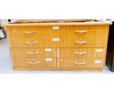 A modern light oak artists supply chest incorporating 2 long drawers 4 half-width drawers to one side, cupboards to the other