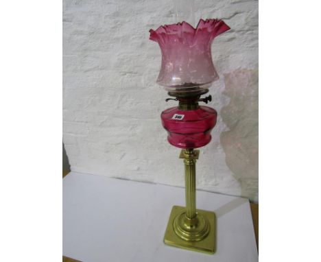 ANTIQUE OIL LAMP, brass column base cranberry glass reservoir oil lamp with floral acid etched cranberry tinted shade 