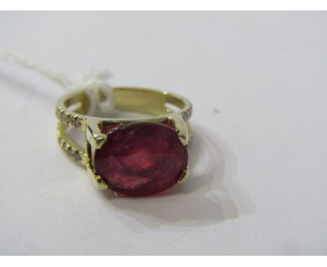 14CT YELLOW GOLD RUBY &amp; DIAMOND RING, principal oval cut ruby in excess of 3ct in high 4 claw setting with accent diamond