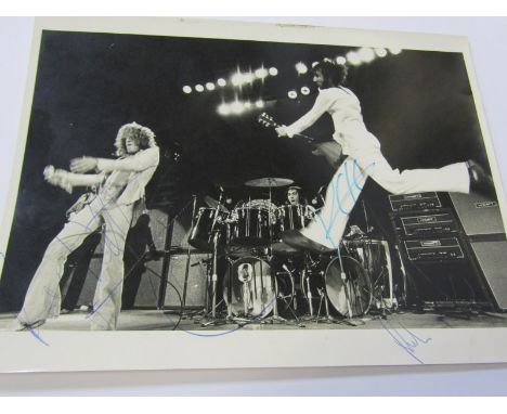 THE WHO, an early concert photograph of Roger Daltrey, Pete Townsend &amp; Keith Moon, signed by the artists together with 2 