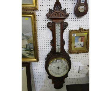 EDWARDIAN ANEROID BAROMETER, carved oak casing by J. Steward, 35" height 