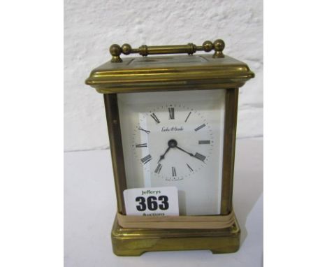 CARRIAGE CLOCK, a brass cased carriage clock with dial signed Lesley P Dembo (1 panel loose) 