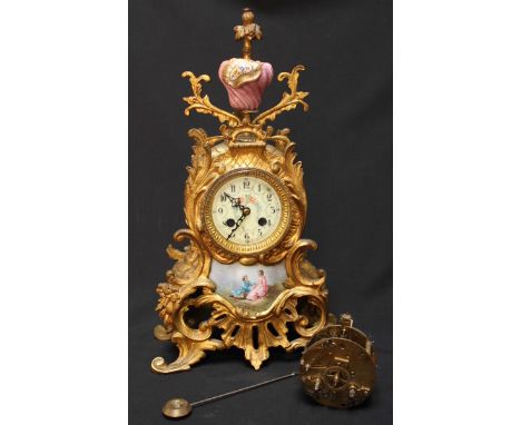 A late 19th century French ormolu mantel clock, with porcelain panels and urn finial, movement separated but present. 43 cm h