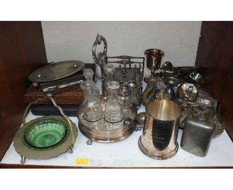 SECTION 14. A shelf of assorted silver plated items, including a cruet set, butter dish, tankard, goblets, cased cutlery and 