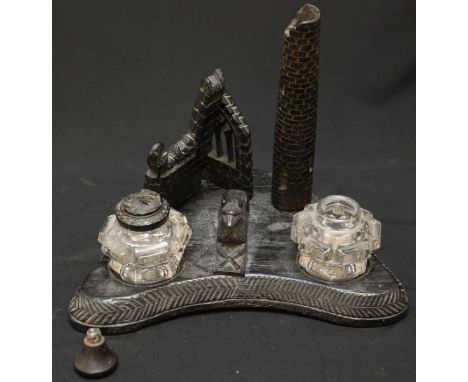 A late 19th century German black forest carved inkwell, carved with architectural elements.