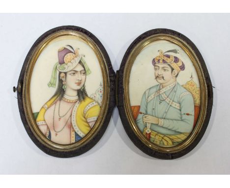 An early 20th Indian double miniature portrait of a man and woman, in ceremonial or wedding dress, painted on ivory and mount