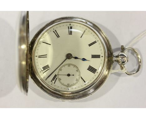 A Victorian silver half hunter pocket watch, hallmarked London 1879, with white enamel dial, black Roman numerals and subsidi