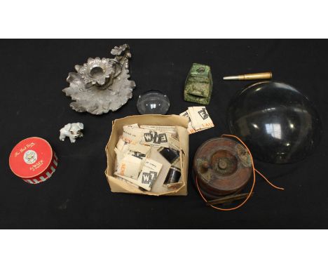 A group of assorted items including a silver plated oak leaf chamber stick, two glass lens, an Allcocks fishing reel, a Wade 