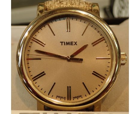 Boxed new old stock gents gold tone Timex wristwatch with gold buttons on rubber strap  CONDITION REPORT: This item is workin