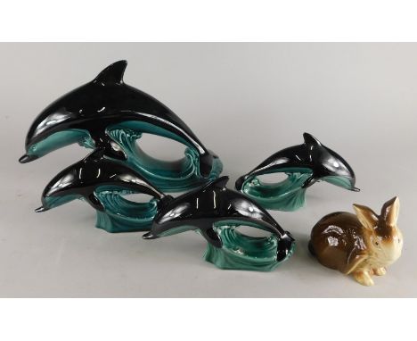 A collection of Poole pottery, to include four dolphins and a rabbit