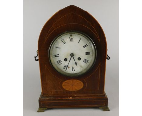 An early 20thC oak lancet shaped mantel clock, with a white enamel dial, two side handles and ogee bracket feet (AF), 31cm hi