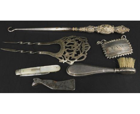 Miscellaneous items of small silver, etc., to include a tooth brush, button hook, brandy decanter label, etc.