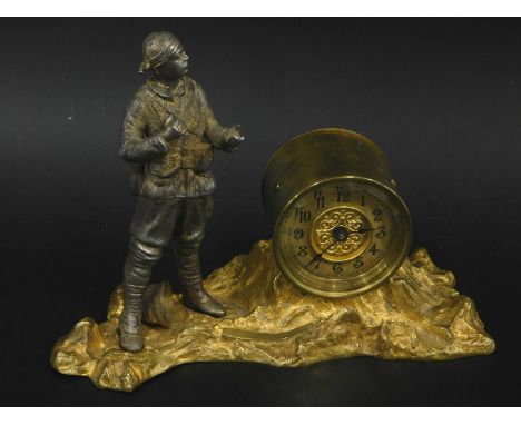 A novelty early 20thC time piece, modelled in the form of a first World War soldier on a gilt metal stylised rock base, proba